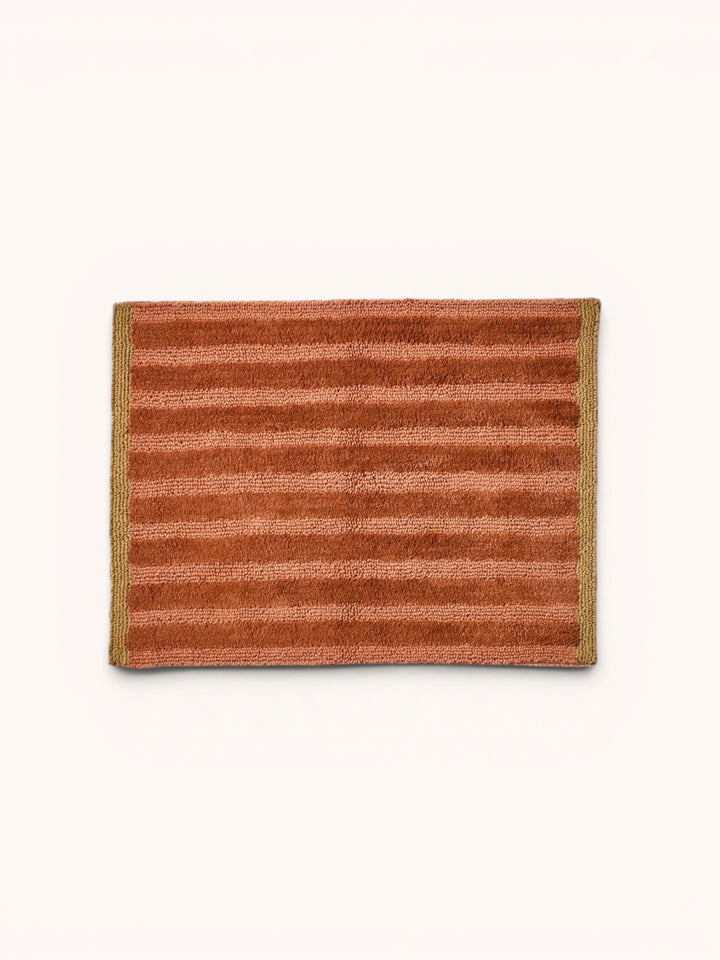 Bonnie and Neil stripe reversible bath mat in terracotta, styled