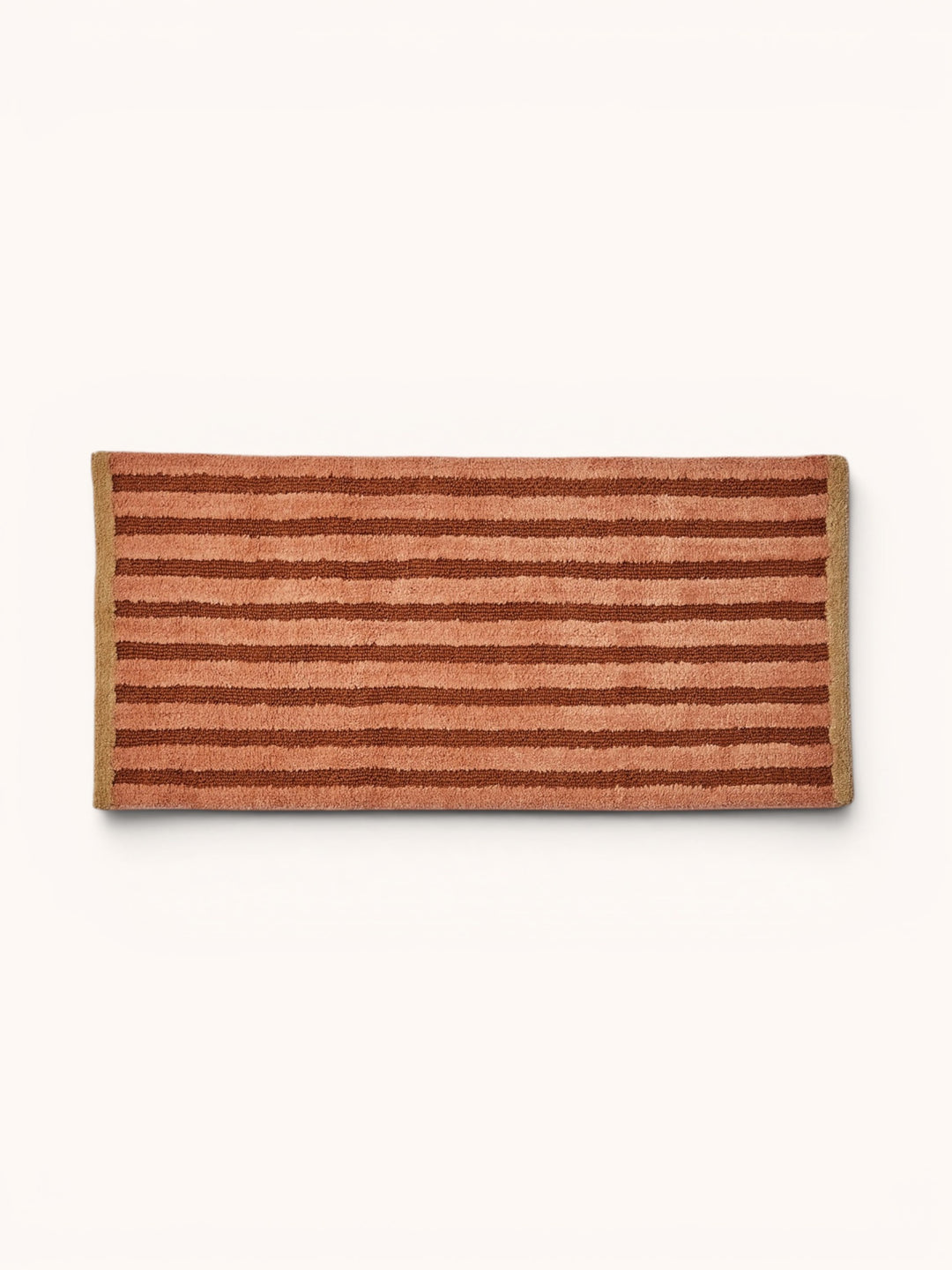 Bonnie and Neil stripe reversible long bath mat in terracotta, in a bathroom