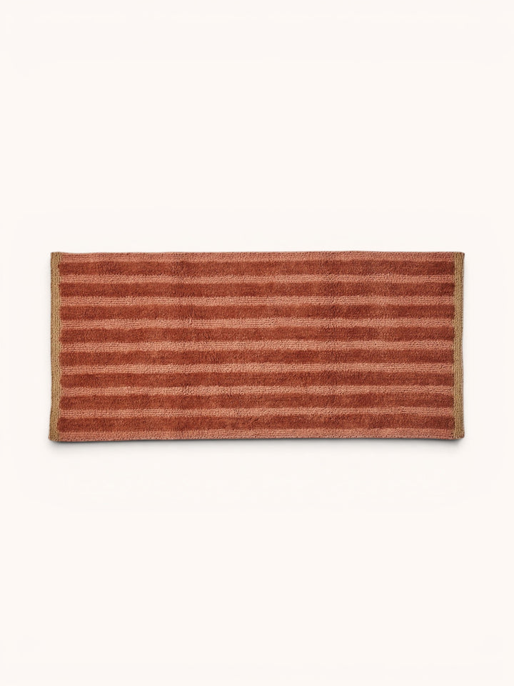 Bonnie and Neil stripe reversible long bath mat in terracotta, styled