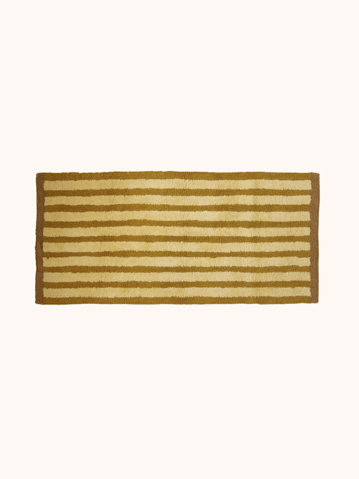 Bonnie and Neil stripe reversible long bath mat in mustard, styled