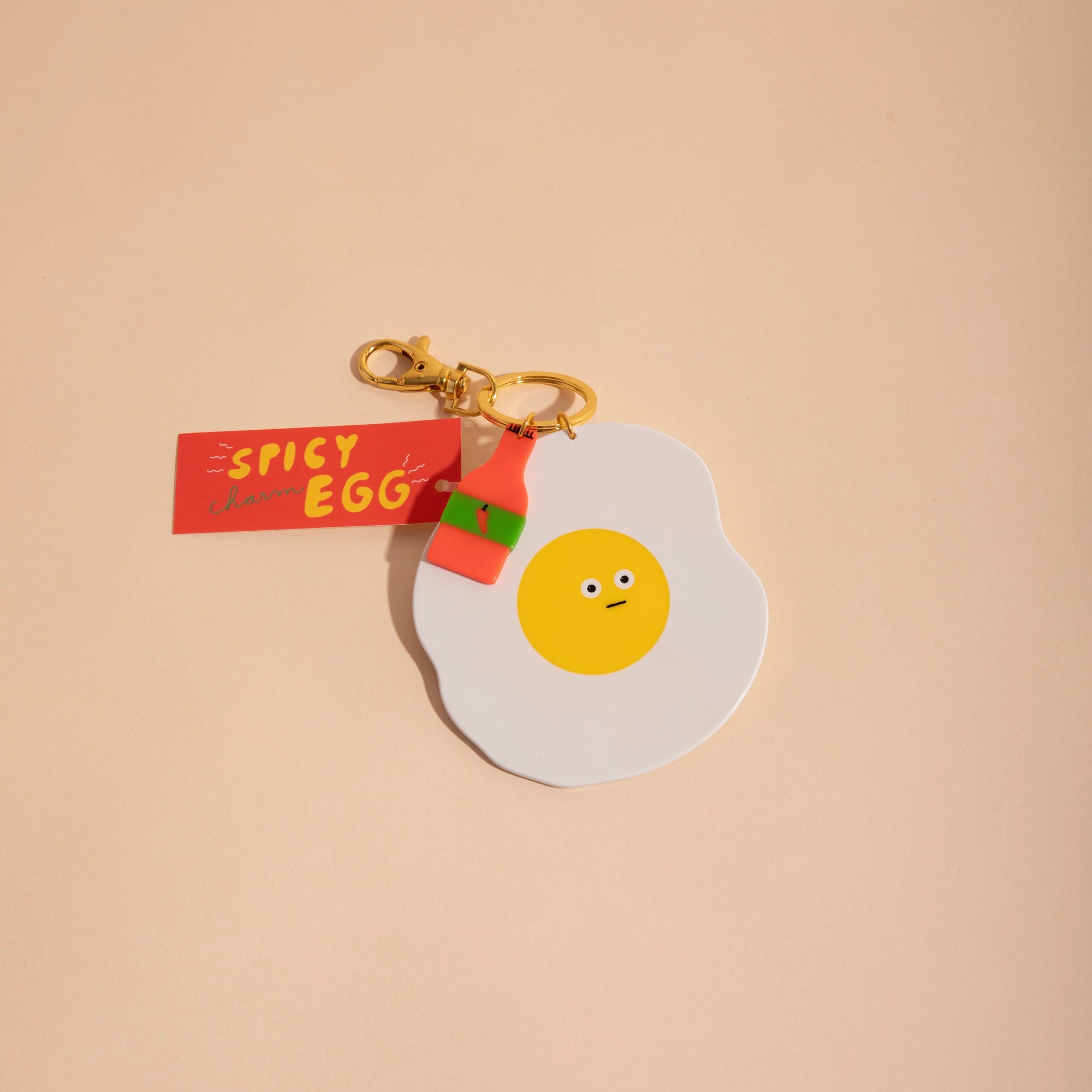 CAROLYN SUZUKI STUDIO SPICY EGG CHARM KEYCHAIN
