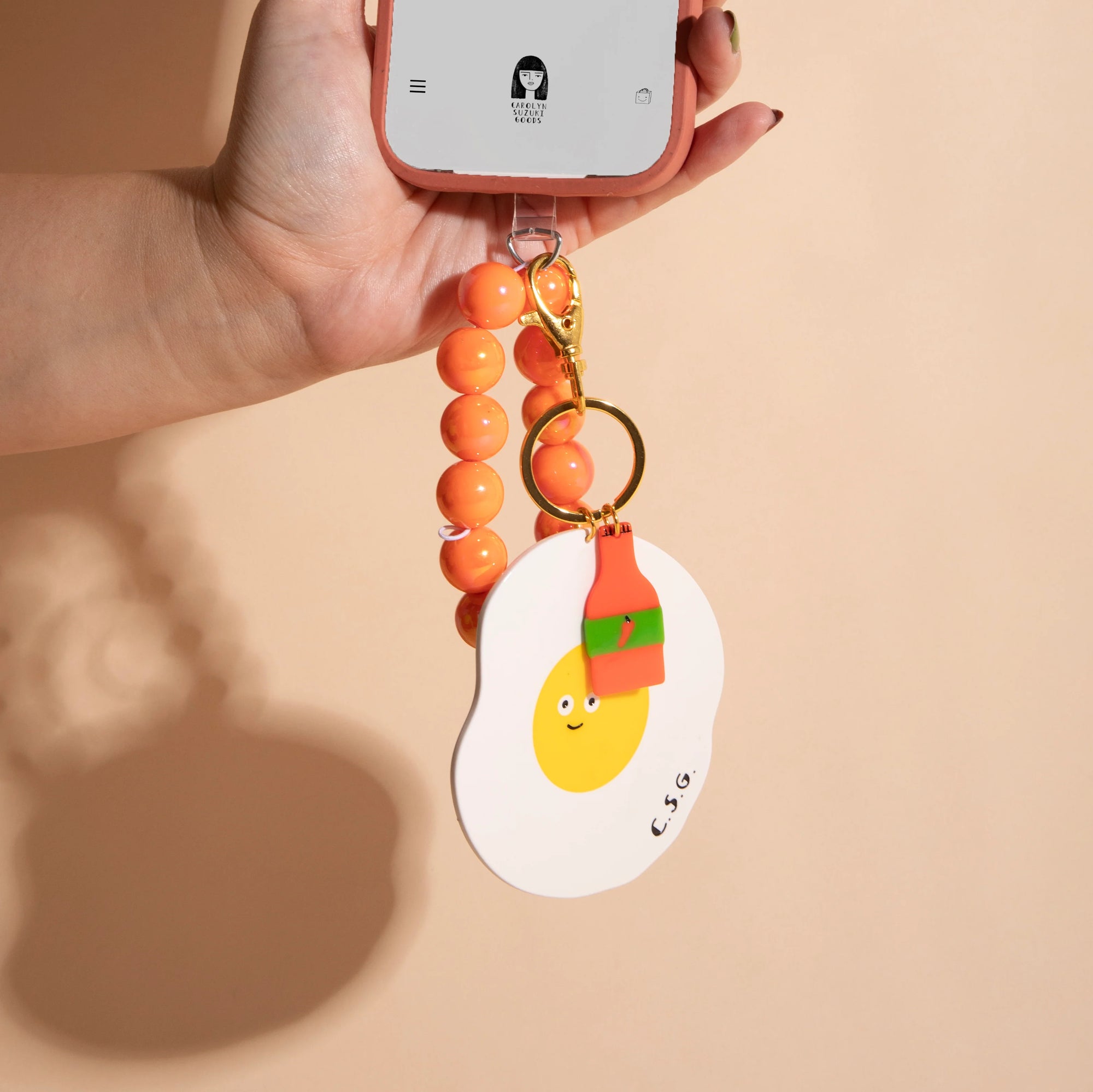CAROLYN SUZUKI STUDIO SPICY EGG CHARM KEYCHAIN